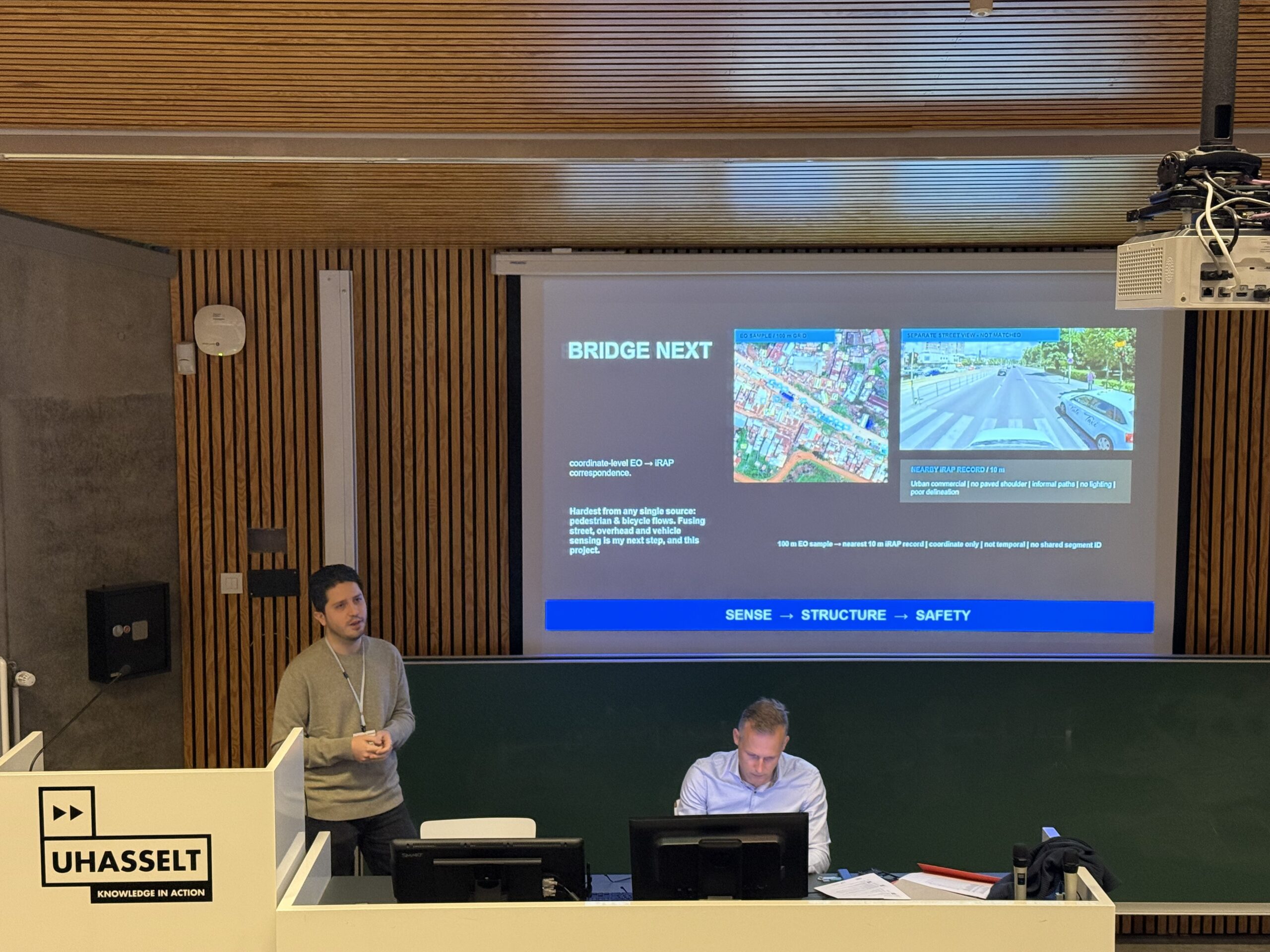 Doctoral candidate presenting the Bridge Next research on fusing street-level and overhead imagery with iRAP road safety data